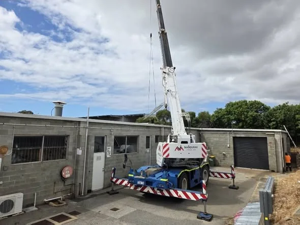 Crane lifting materials onto the roof