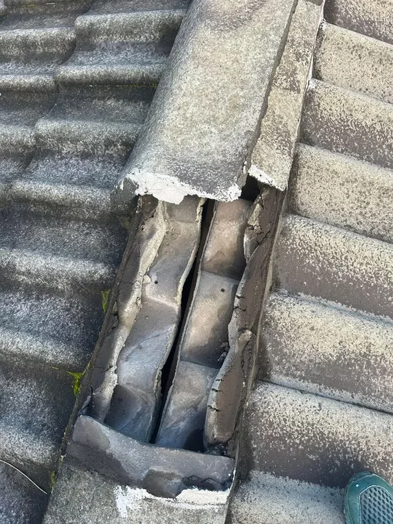 Cracked and deteriorated ridge capping with failed pointing